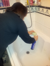 Cardiff Home Cleaner cleaning a bath and tiles